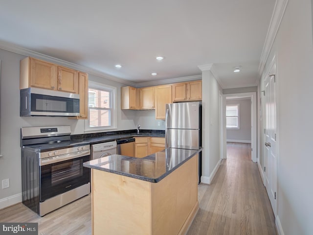 kitchen with appliances with stainless steel finishes, ornamental molding, and a kitchen island