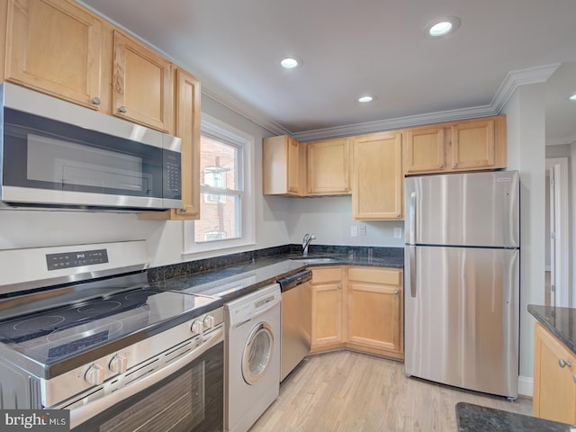 kitchen featuring crown molding, light hardwood / wood-style flooring, washer / dryer, sink, and stainless steel appliances