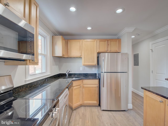 kitchen featuring crown molding, dark stone counters, light wood-type flooring, sink, and stainless steel appliances