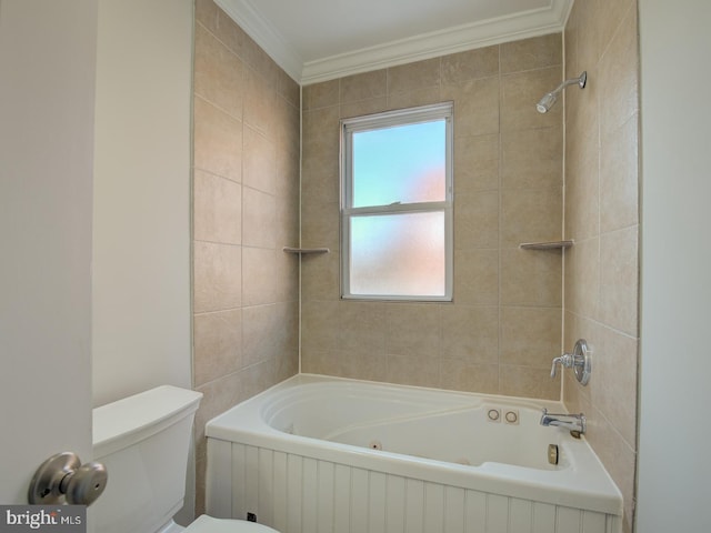 bathroom with crown molding, toilet, and tiled shower / bath