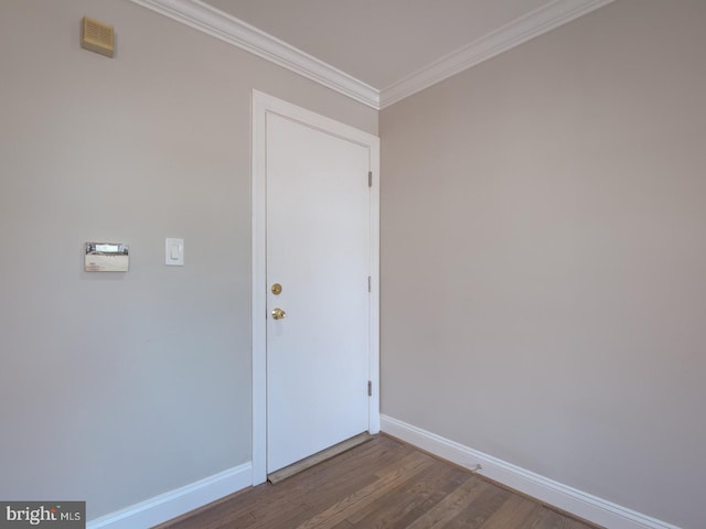 interior space with hardwood / wood-style floors and crown molding