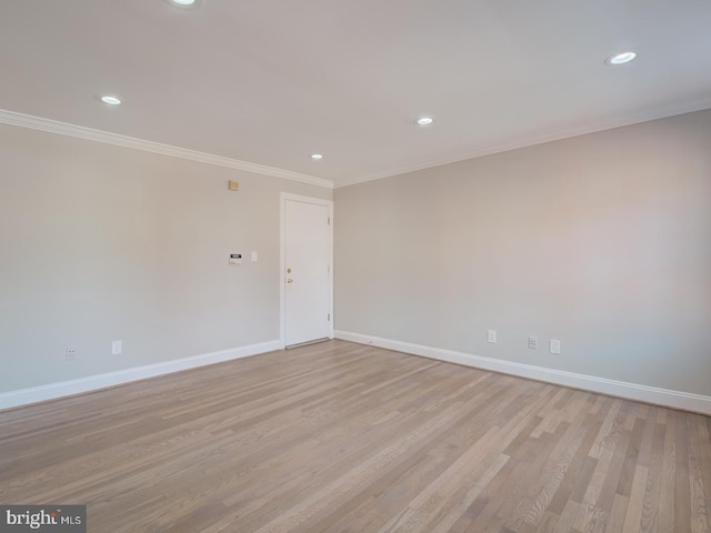 unfurnished room with light wood-type flooring and ornamental molding