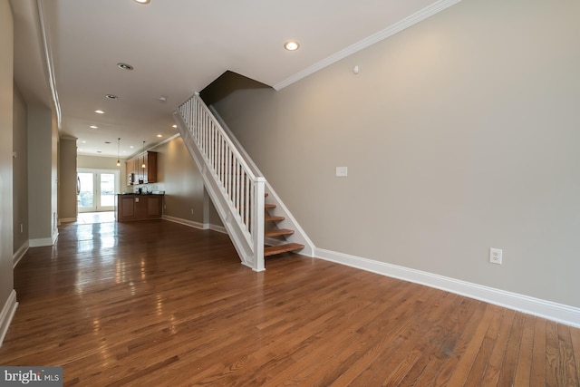 staircase with baseboards, recessed lighting, wood finished floors, and crown molding