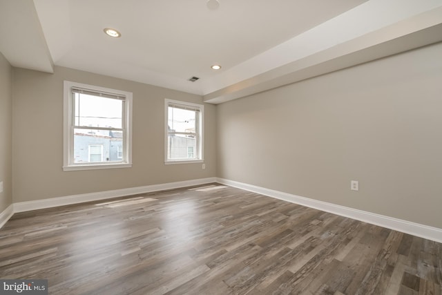 unfurnished room featuring dark hardwood / wood-style flooring