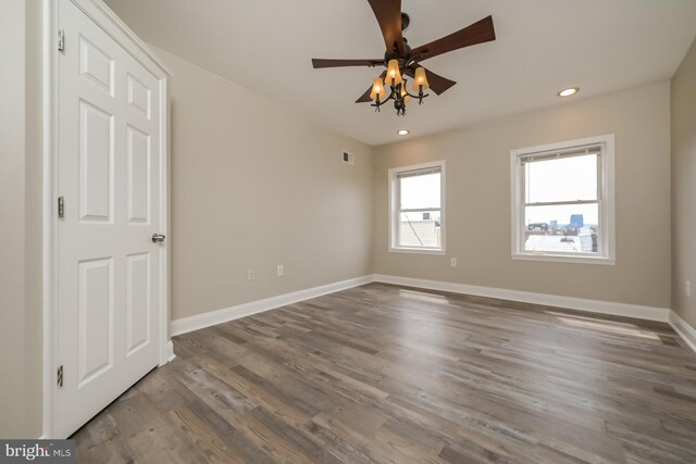 unfurnished room featuring recessed lighting, ceiling fan, visible vents, baseboards, and wood finished floors