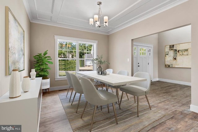 dining area featuring ornamental molding, hardwood / wood-style floors, and a chandelier