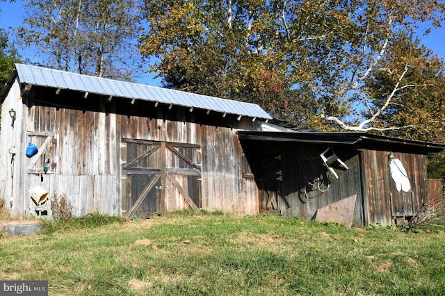 view of outbuilding with a lawn