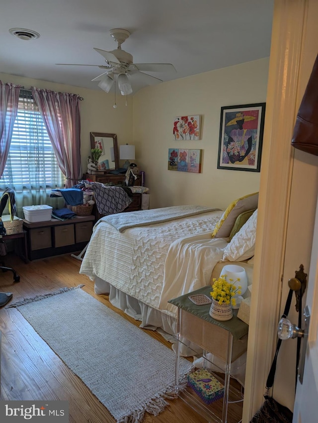 bedroom with hardwood / wood-style flooring and ceiling fan