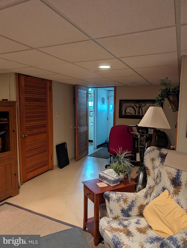 living room with a drop ceiling