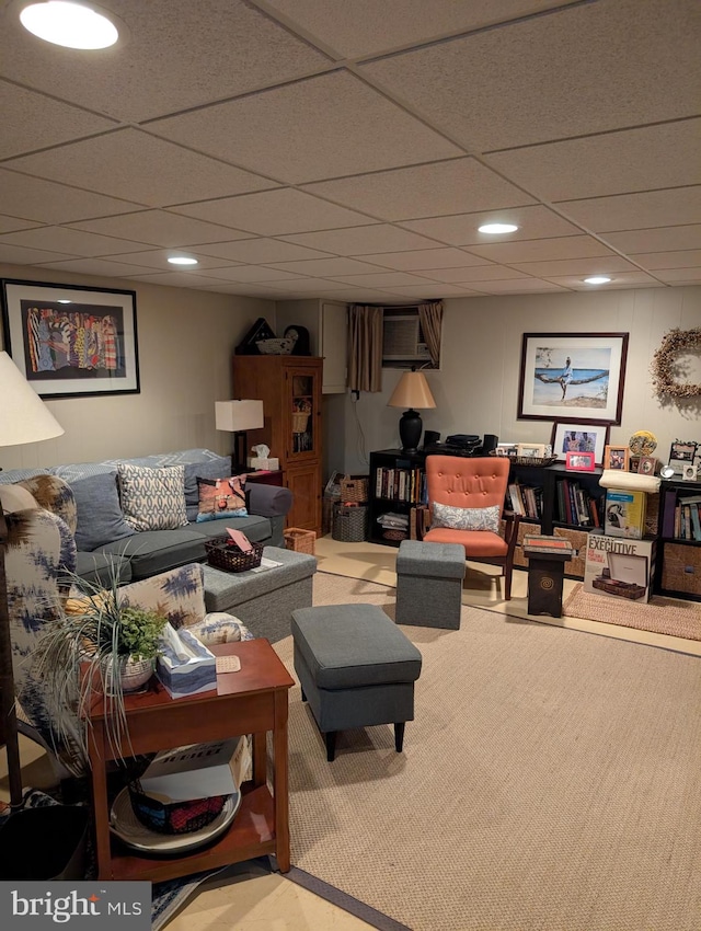 living room featuring a paneled ceiling and light colored carpet