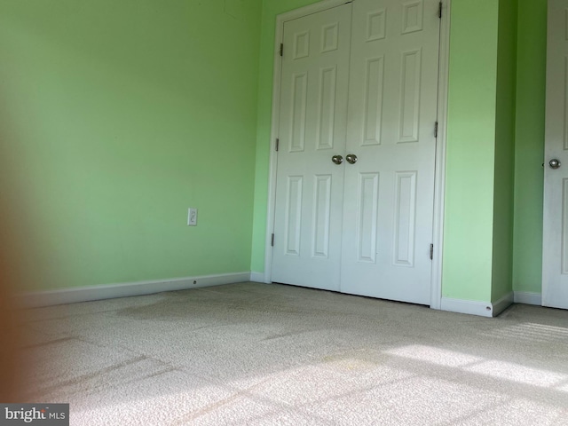 unfurnished bedroom featuring a closet and carpet floors