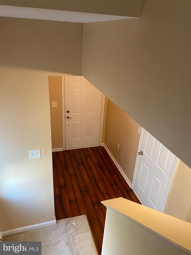 hallway featuring dark hardwood / wood-style flooring