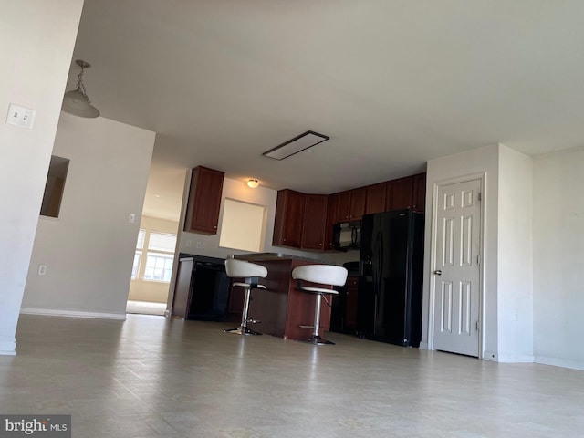 kitchen featuring black appliances and a kitchen bar