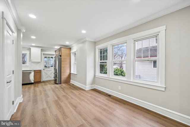 unfurnished living room featuring light hardwood / wood-style flooring and ornamental molding