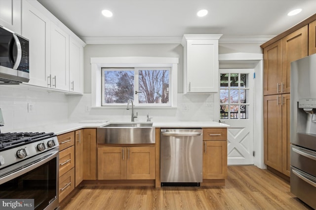 kitchen featuring white cabinets, a healthy amount of sunlight, sink, and stainless steel appliances