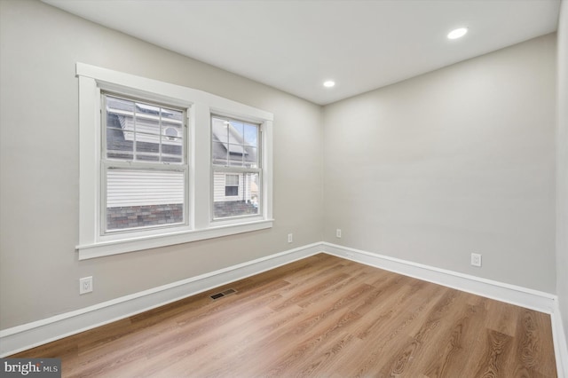 unfurnished room with light wood-type flooring