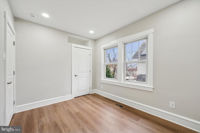 unfurnished room featuring light hardwood / wood-style flooring