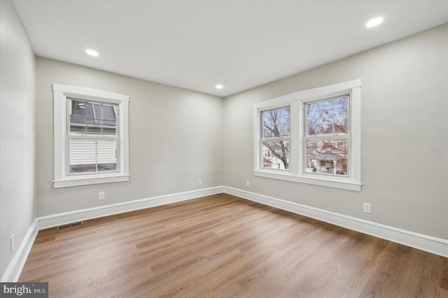 unfurnished room with hardwood / wood-style floors