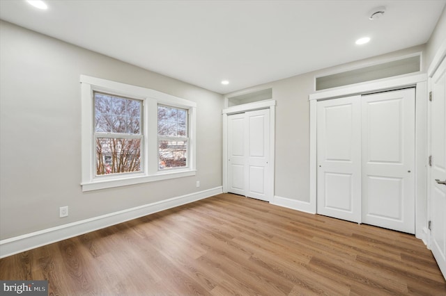 unfurnished bedroom with hardwood / wood-style floors