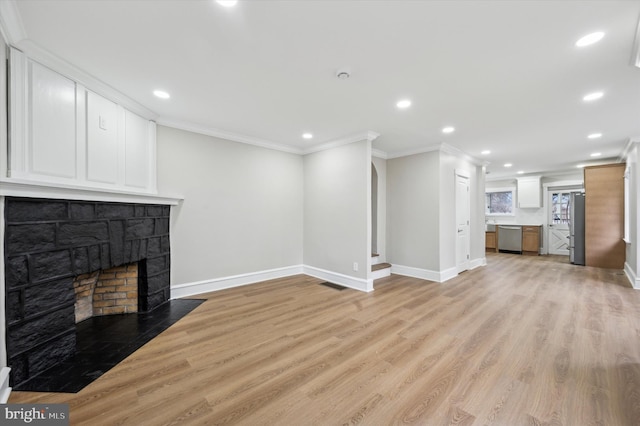 unfurnished living room featuring a fireplace, light hardwood / wood-style flooring, and ornamental molding