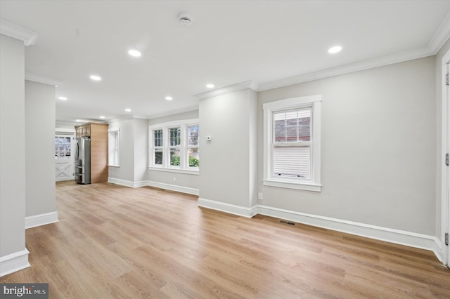 unfurnished living room featuring crown molding, light hardwood / wood-style flooring, and a healthy amount of sunlight