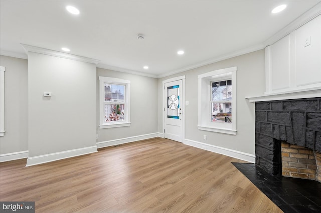 unfurnished living room with light hardwood / wood-style floors and ornamental molding