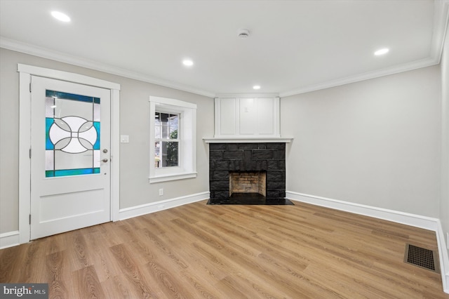 unfurnished living room featuring a fireplace, light hardwood / wood-style floors, and ornamental molding