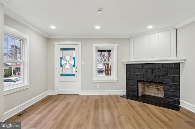 unfurnished living room with light hardwood / wood-style flooring and ornamental molding