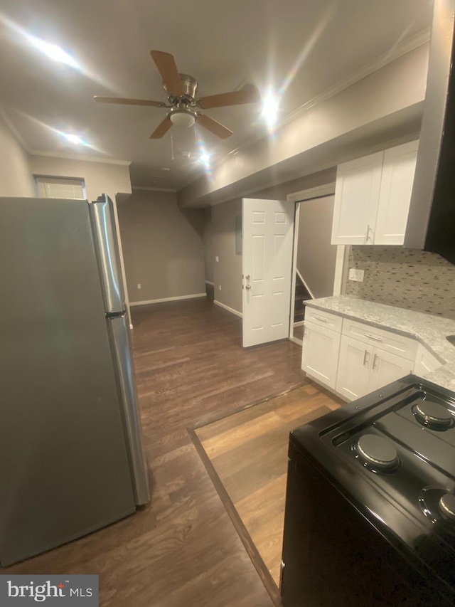 kitchen featuring light stone countertops, dark hardwood / wood-style flooring, electric range, stainless steel fridge, and white cabinets