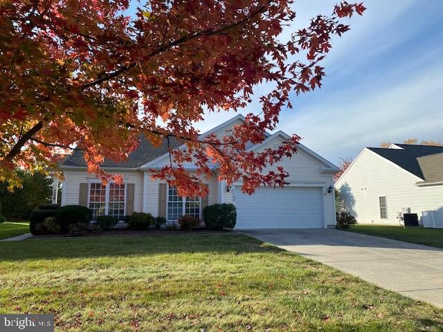 view of front of house with a garage and a front lawn