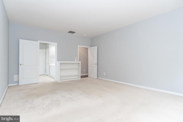 unfurnished bedroom featuring light carpet