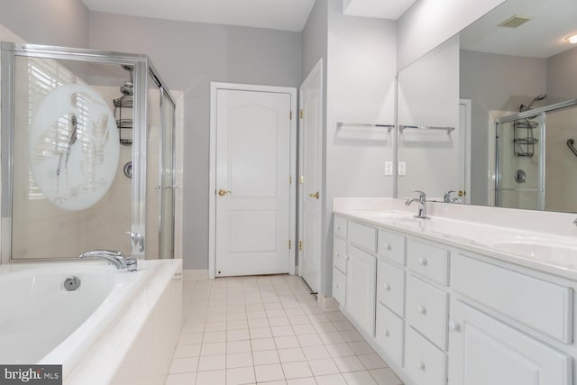 bathroom with tile patterned flooring, vanity, and plus walk in shower