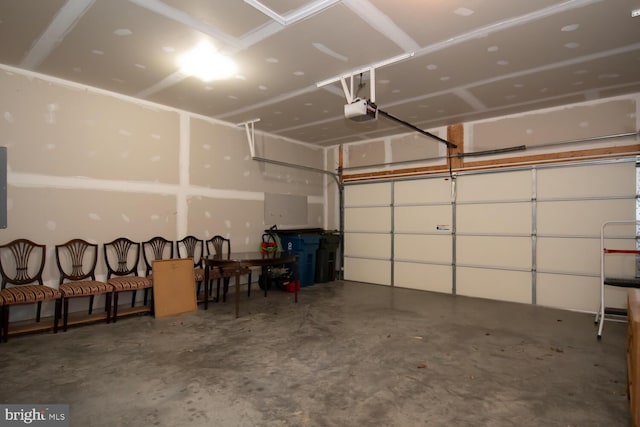 garage featuring electric panel and a garage door opener