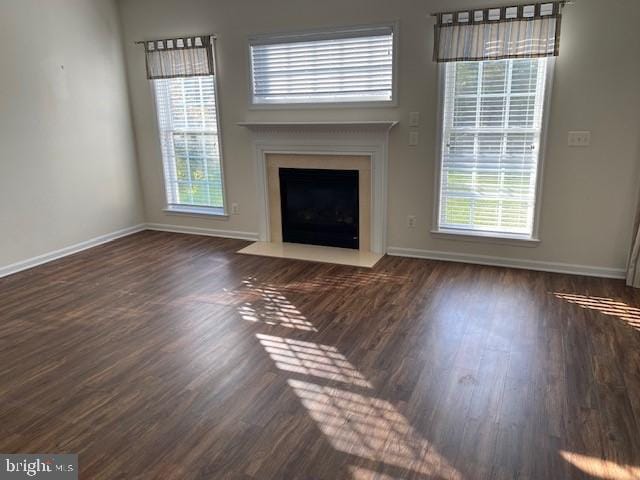 unfurnished living room with dark wood-type flooring