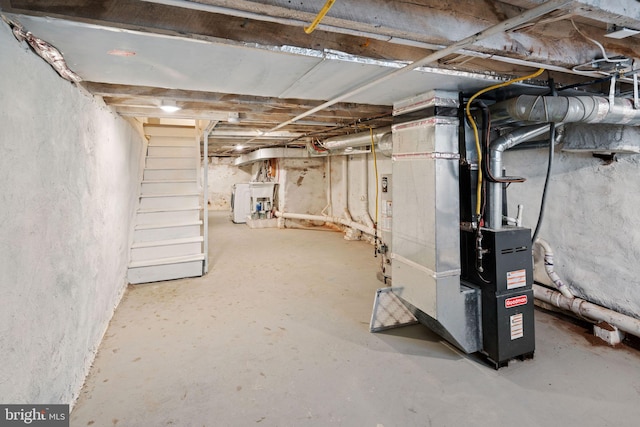 basement featuring washer / dryer and heating unit