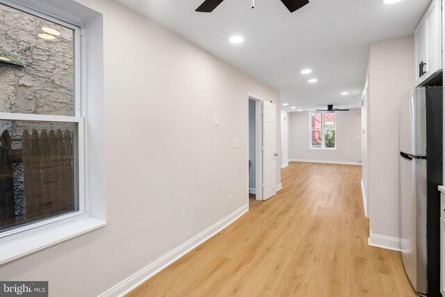 hallway with light wood-type flooring