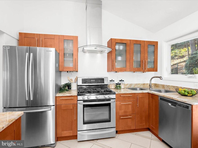 kitchen featuring light stone countertops, appliances with stainless steel finishes, sink, light tile patterned floors, and lofted ceiling