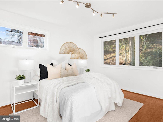 bedroom with hardwood / wood-style flooring