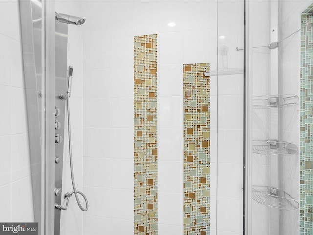 bathroom with a shower with door