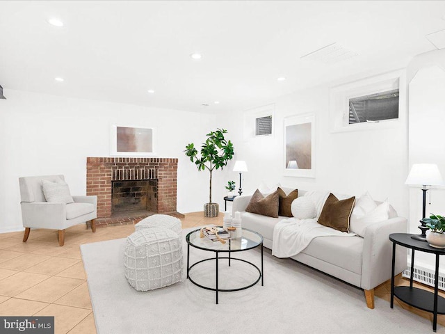 living room featuring a fireplace and light tile patterned floors