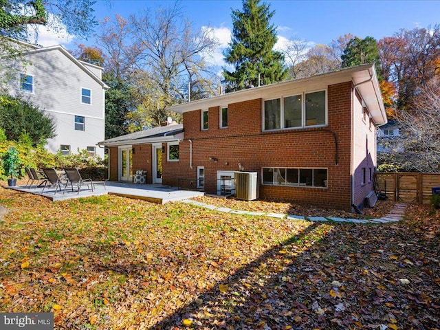 rear view of property with cooling unit and a patio area