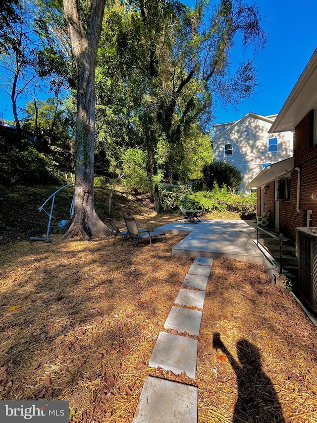 view of yard with cooling unit and a patio area