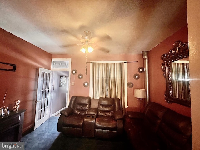 living room with decorative columns, a textured ceiling, and ceiling fan