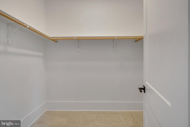 walk in closet featuring light tile patterned flooring