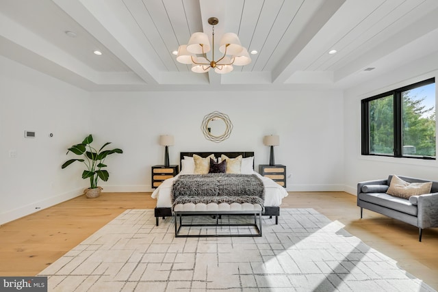 bedroom featuring beamed ceiling, light hardwood / wood-style flooring, and an inviting chandelier