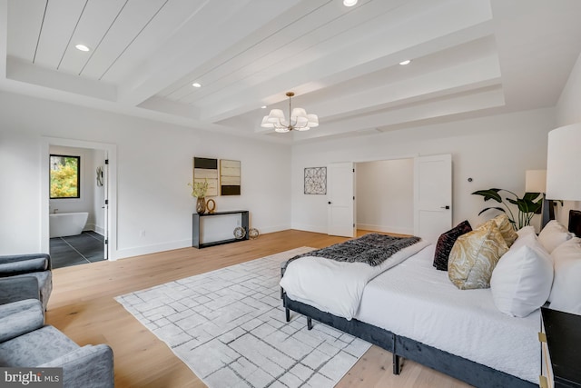 bedroom with ensuite bathroom, hardwood / wood-style floors, beam ceiling, and a chandelier