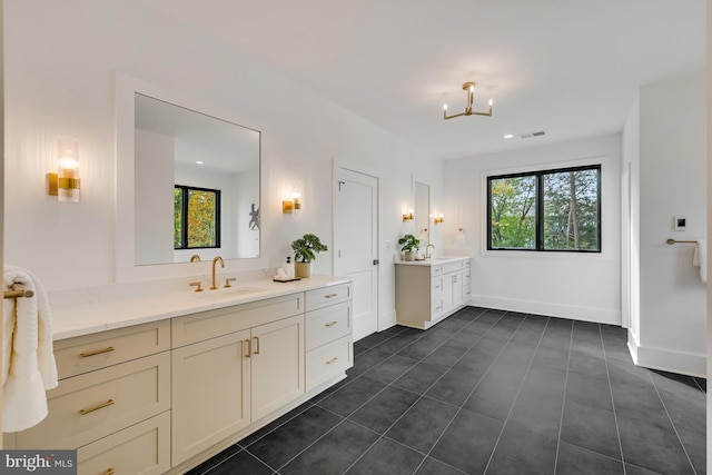 bathroom featuring vanity, tile patterned floors, and an inviting chandelier