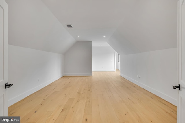 bonus room with light hardwood / wood-style flooring and lofted ceiling