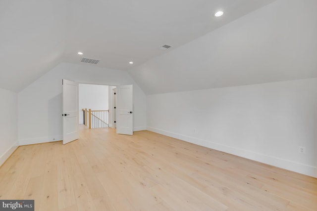 bonus room featuring light hardwood / wood-style flooring and vaulted ceiling