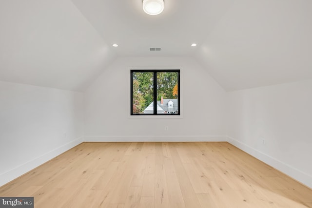 bonus room with lofted ceiling and light hardwood / wood-style flooring